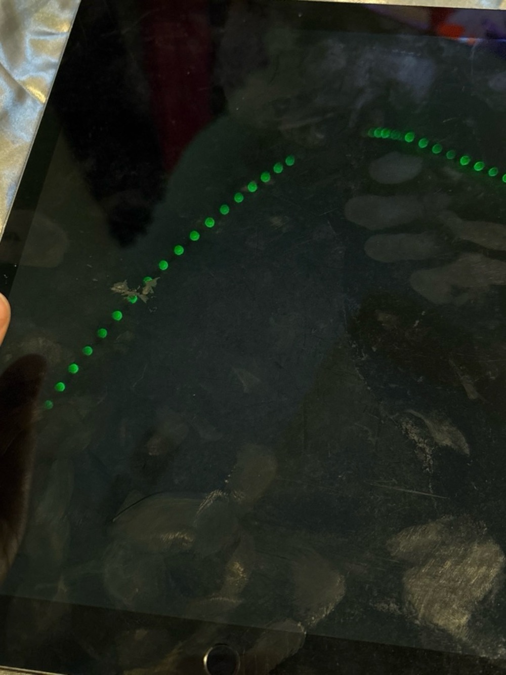 Apple Black Tablet with Green LED Dot Reflection